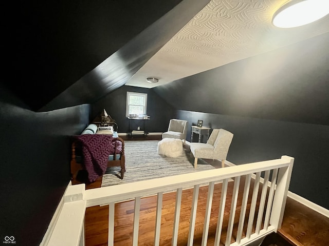 bedroom featuring baseboards and vaulted ceiling
