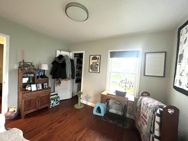 office space with baseboards and wood finished floors