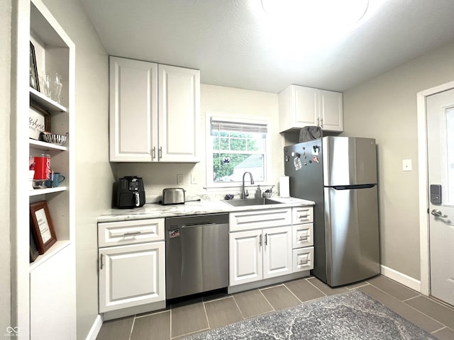 kitchen with white cabinets, wood finish floors, open shelves, a sink, and stainless steel appliances