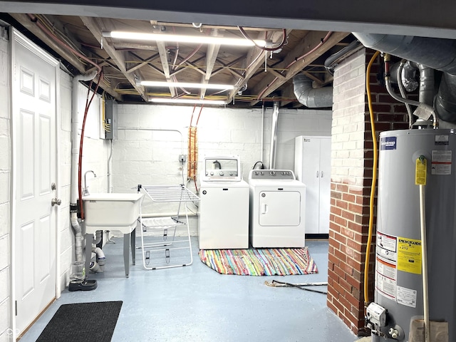 laundry area featuring laundry area, a sink, water heater, and independent washer and dryer