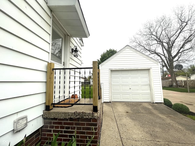 detached garage with fence and driveway