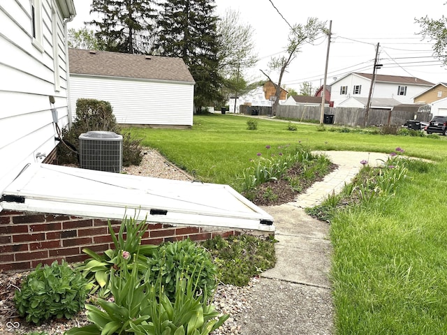 view of yard featuring fence and cooling unit