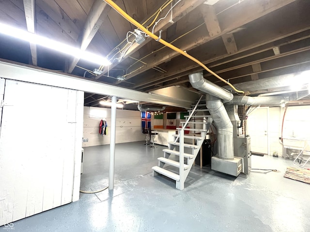 unfinished below grade area with heating unit and stairs