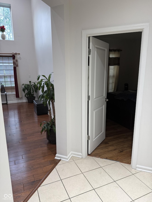 hall with baseboards and light wood finished floors
