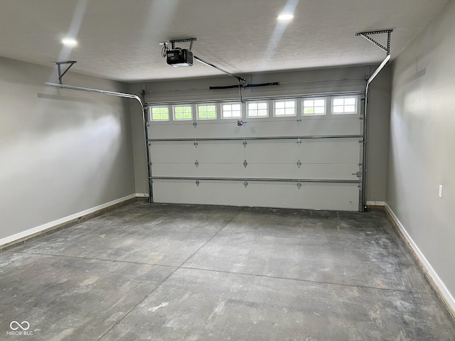 garage featuring baseboards and a garage door opener