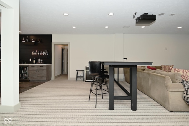 interior space with recessed lighting, carpet flooring, a dry bar, and beverage cooler
