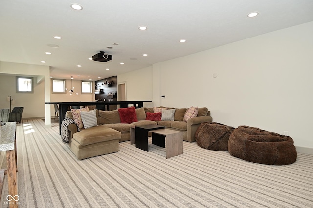 living area featuring light carpet, indoor bar, and recessed lighting