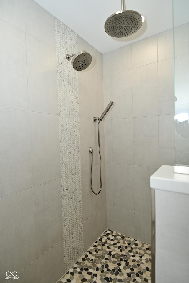 full bath featuring tile walls and tiled shower