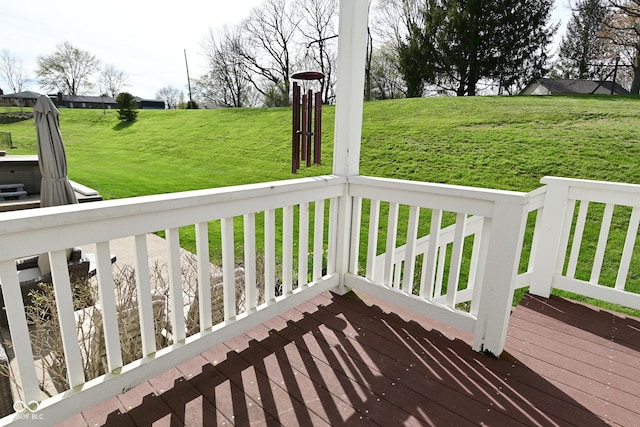 wooden terrace featuring a yard