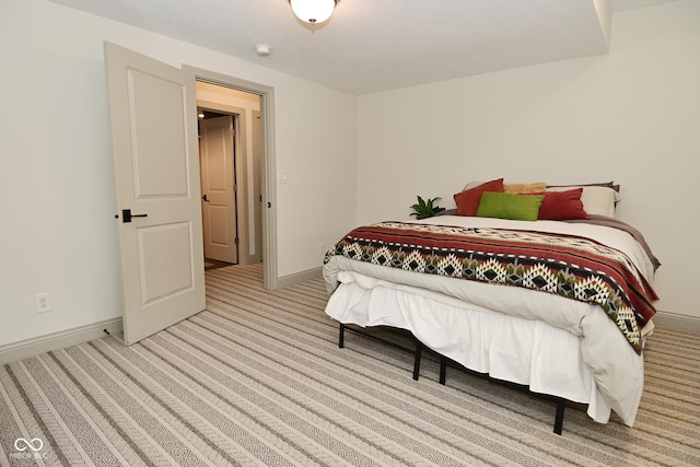 carpeted bedroom featuring baseboards