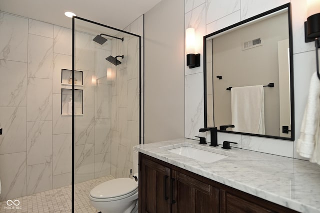 full bathroom with vanity, visible vents, toilet, and a shower stall