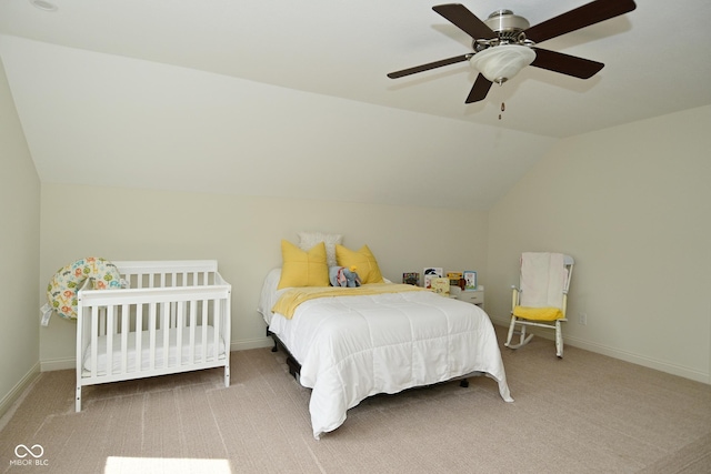 carpeted bedroom with vaulted ceiling, baseboards, and a ceiling fan