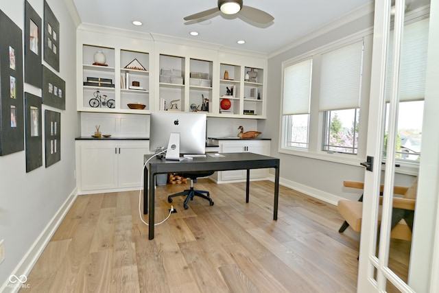 home office with ceiling fan, light wood-style flooring, crown molding, and baseboards