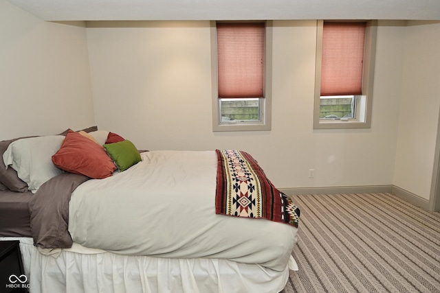carpeted bedroom with baseboards