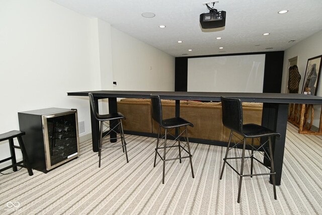 interior space featuring wine cooler, a bar, recessed lighting, visible vents, and light colored carpet