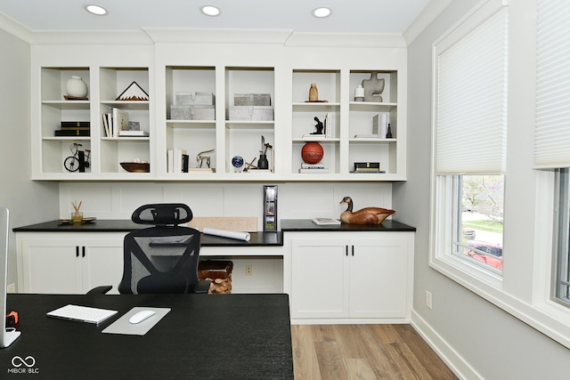 home office with built in desk, ornamental molding, light wood-style flooring, and recessed lighting