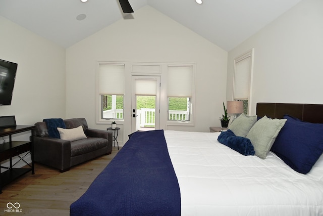bedroom featuring access to outside, wood finished floors, lofted ceiling, and recessed lighting