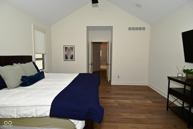 bedroom with lofted ceiling, baseboards, visible vents, and wood finished floors