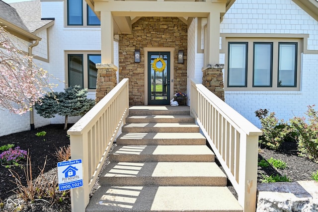 doorway to property with stone siding