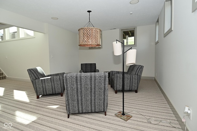 dining space with baseboards, a wealth of natural light, and light carpet