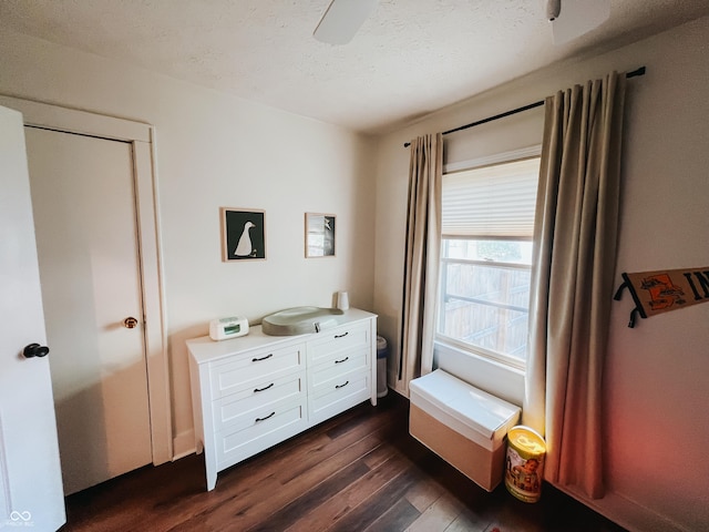 bedroom with dark wood-style flooring and a textured ceiling