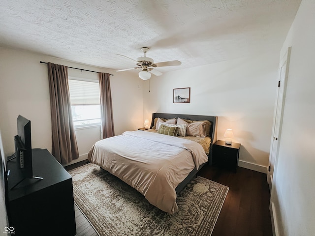 bedroom with baseboards, a ceiling fan, a textured ceiling, and wood finished floors