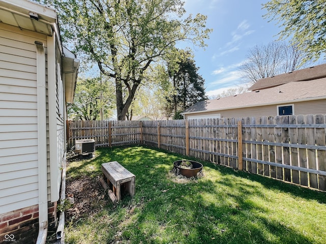 view of yard with central AC and a fenced backyard