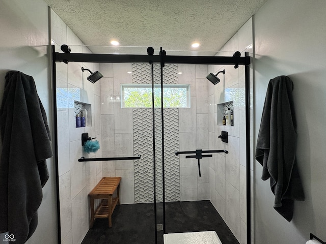 bathroom featuring a shower stall, recessed lighting, and a textured ceiling