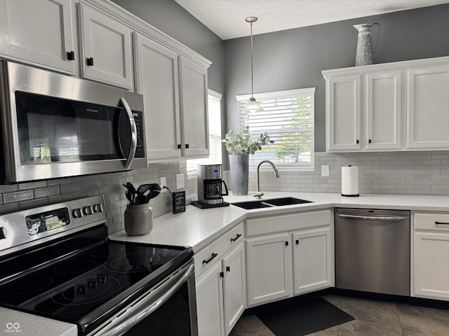 kitchen featuring white cabinets, stainless steel appliances, and a sink