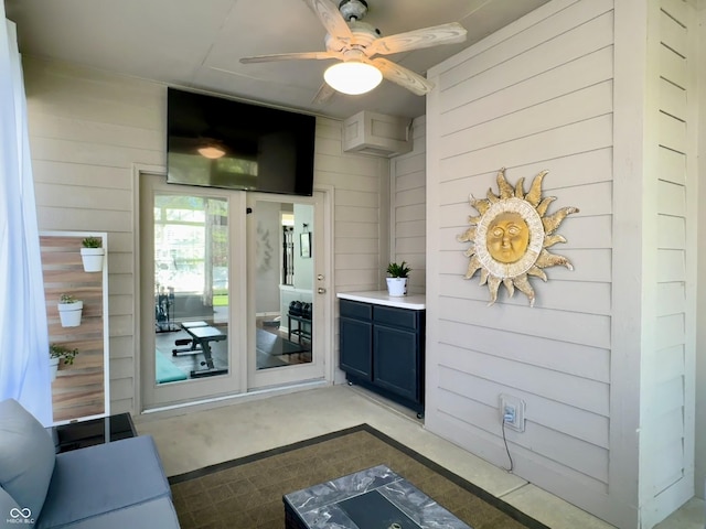 view of exterior entry featuring a ceiling fan