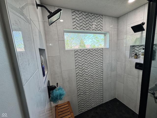 full bath featuring a textured ceiling and a walk in shower