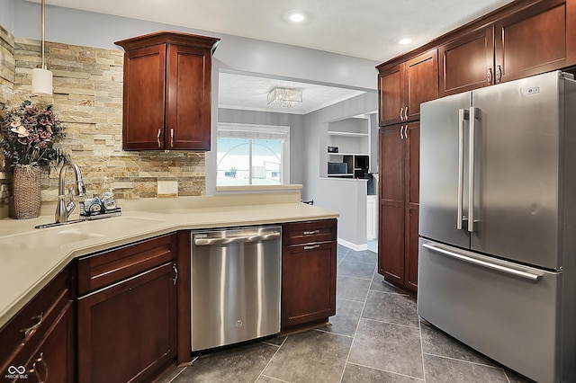 601 Shady Ln, Greenwood, IN 46142 - kitchen with appliances with stainless steel finishes, tasteful backsplash, light countertops, a sink, and a peninsula