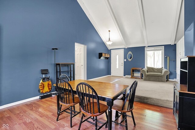 601 Shady Ln, Greenwood, IN 46142 - dining space featuring baseboards, beam ceiling, light wood finished floors, and high vaulted ceiling