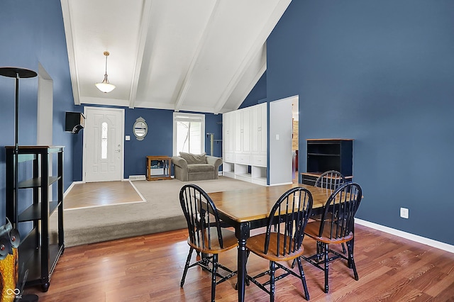 601 Shady Ln, Greenwood, IN 46142 - dining space featuring baseboards, beam ceiling, high vaulted ceiling, and wood finished floors