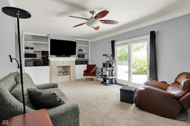 601 Shady Ln, Greenwood, IN 46142 - carpeted living room featuring a ceiling fan, a textured ceiling, a tiled fireplace, and baseboards