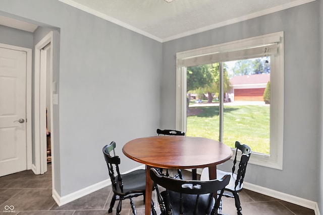 601 Shady Ln, Greenwood, IN 46142 - dining room featuring dark tile patterned floors, ornamental molding, baseboards, and plenty of natural light