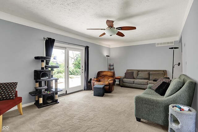 601 Shady Ln, Greenwood, IN 46142 - living room with visible vents, a ceiling fan, a textured ceiling, and light carpet