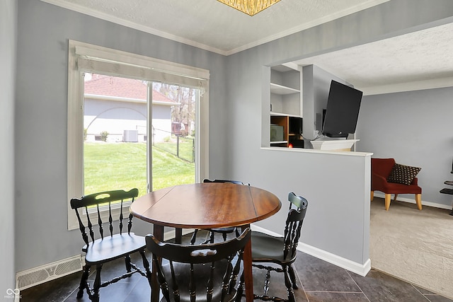 601 Shady Ln, Greenwood, IN 46142 - dining area with crown molding, a textured ceiling, dark carpet, baseboards, and visible vents