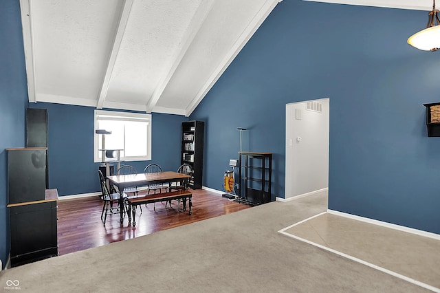 601 Shady Ln, Greenwood, IN 46142 - carpeted dining room featuring lofted ceiling with beams, a textured ceiling, baseboards, wood finished floors, and visible vents