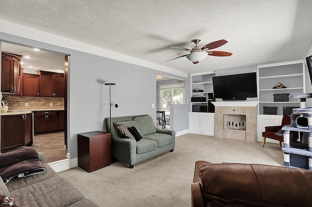 601 Shady Ln, Greenwood, IN 46142 - living room with a fireplace, baseboards, ceiling fan, light colored carpet, and a textured ceiling