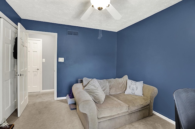 601 Shady Ln, Greenwood, IN 46142 - carpeted living room with baseboards, a ceiling fan, a textured ceiling, and visible vents