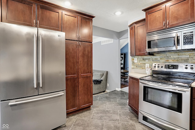 601 Shady Ln, Greenwood, IN 46142 - kitchen featuring visible vents, recessed lighting, light countertops, backsplash, and stainless steel appliances