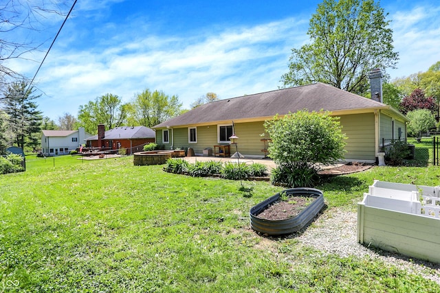 601 Shady Ln, Greenwood, IN 46142 - back of property with fence, a patio, a vegetable garden, a chimney, and a yard