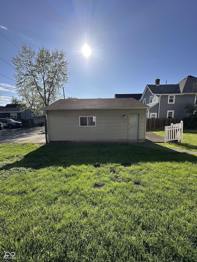 back of house with fence and a yard