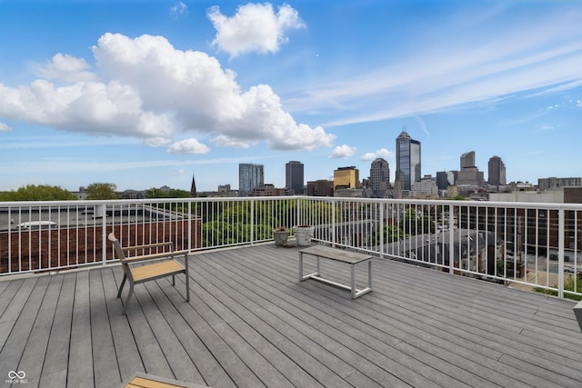 wooden terrace featuring a view of skyline