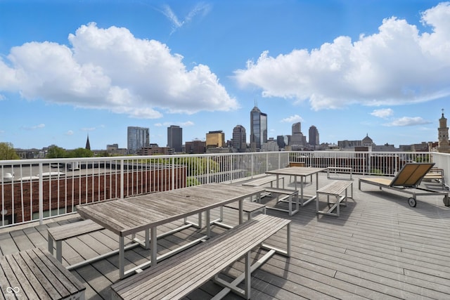 deck featuring a skyline view and outdoor dining space