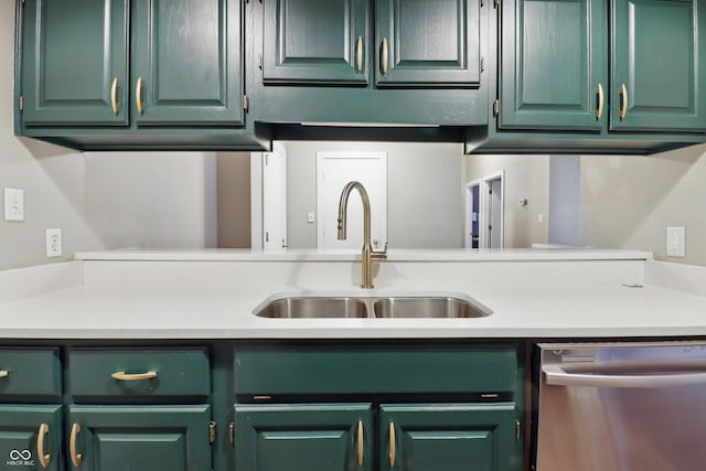 kitchen featuring stainless steel dishwasher, a sink, light countertops, and green cabinetry