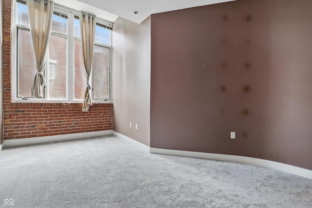 carpeted spare room featuring baseboards