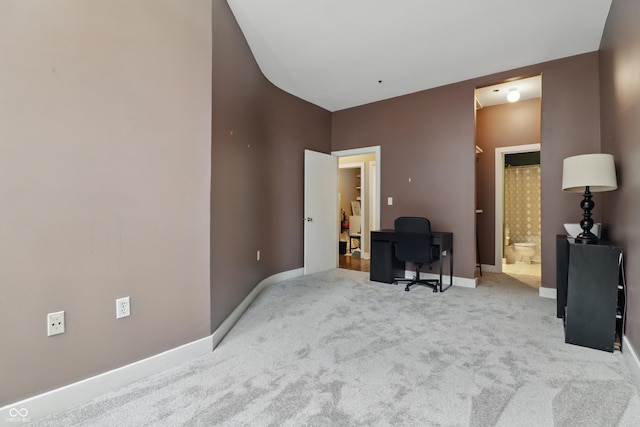 carpeted office featuring baseboards