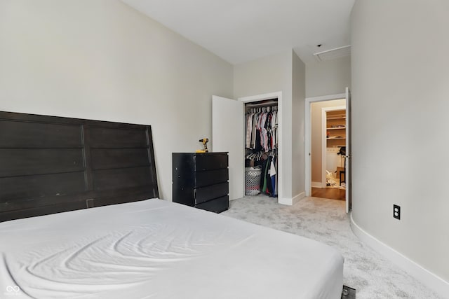 carpeted bedroom featuring baseboards, a closet, and attic access